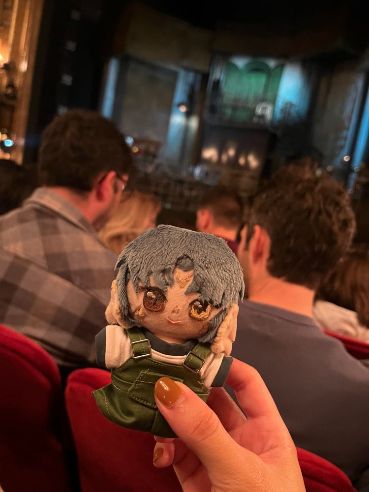 myka doll held out in front of the stage of hadestown