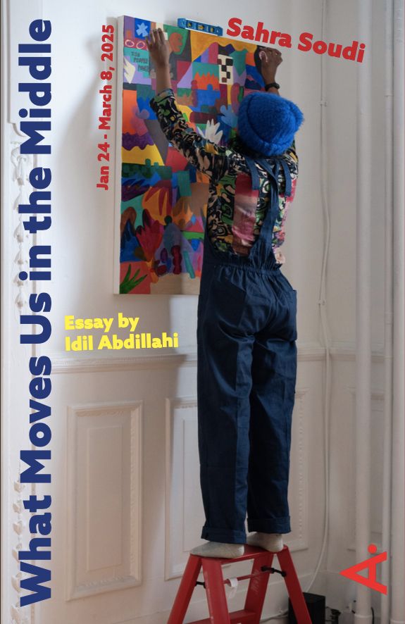A person wearing a vibrant, patterned long-sleeve shirt, blue overalls, and a bright blue knit hat stands on a red step ladder, adjusting a colorful abstract painting on a white wall. The painting features bold geometric shapes in vivid hues of orange, blue, pink, and green. The surrounding text includes the title What Moves Us in the Middle in bold navy blue letters along the left side, with the artist's name, Sahra Soudi, in red at the top. Additional text in yellow and red announces an essay by Idil Abdillahi and exhibition dates from January 24 to March 8, 2025. The setting appears to be a gallery or studio space with white paneled walls.