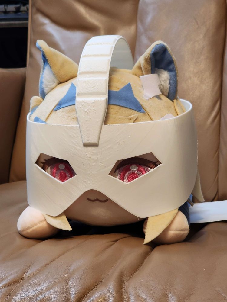 a plush of the Vtuber "Fuwawa" wearing a 3d printed mask worn by the character Char Aznable from the Gundam series.