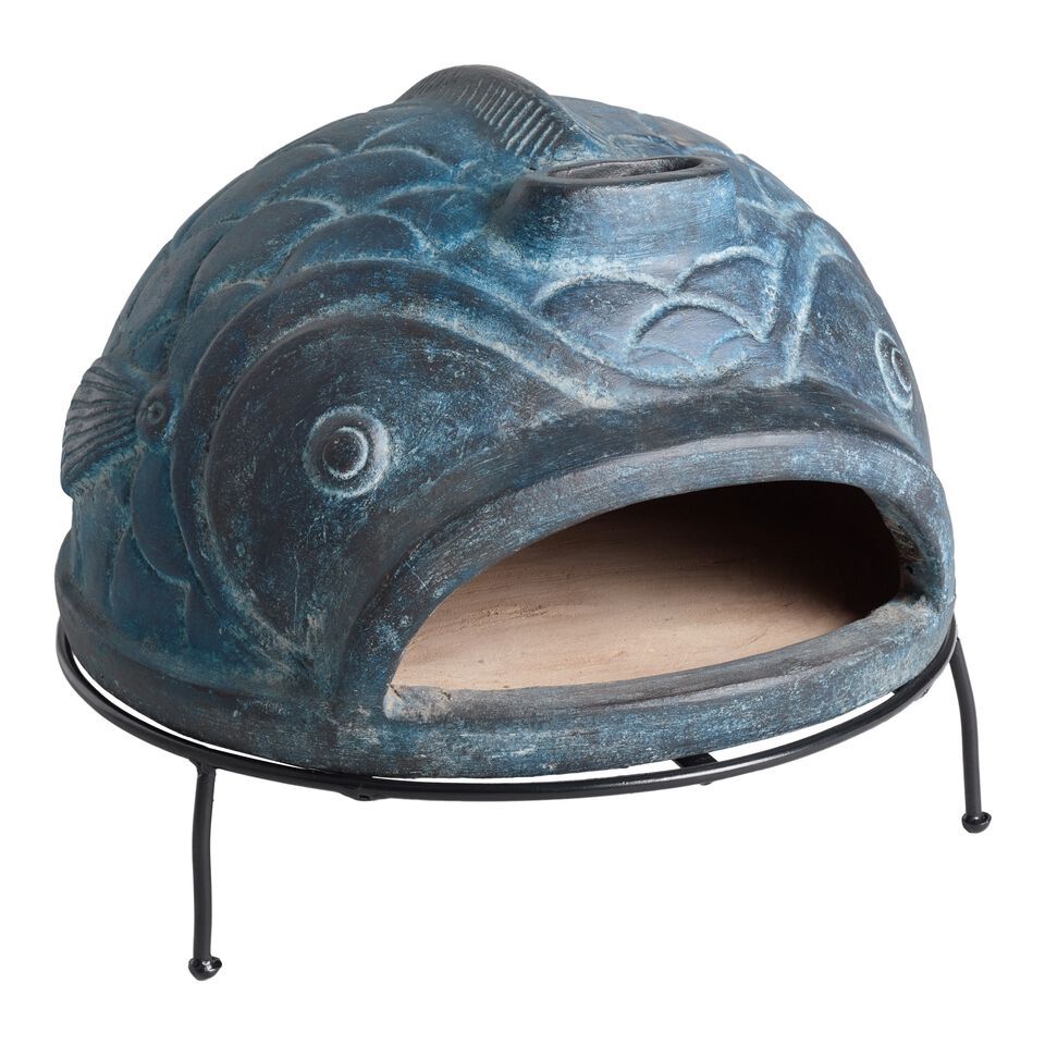 A blue fish shaped terracotta pizza oven.