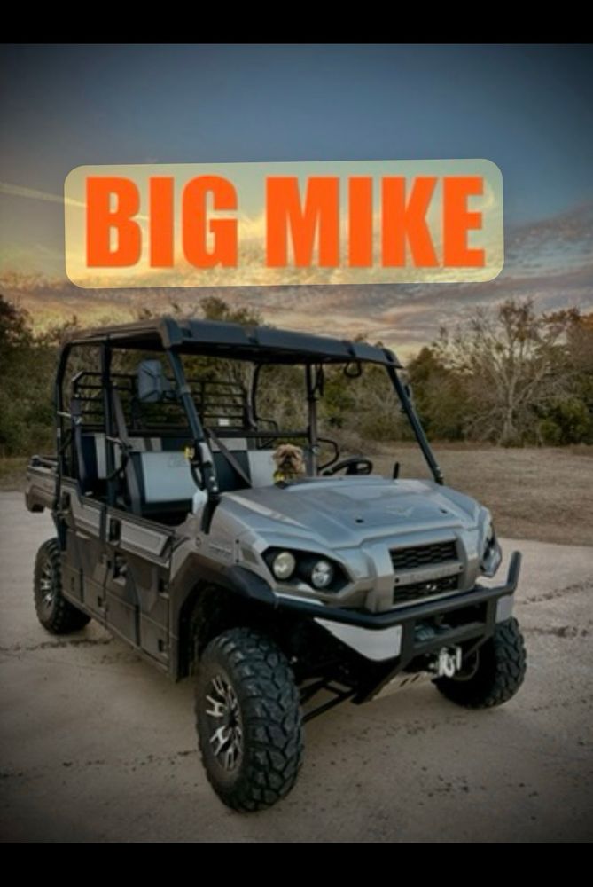 Wally The Griff sitting in a Kawasaki UTV Mule named BIG MIKE. 