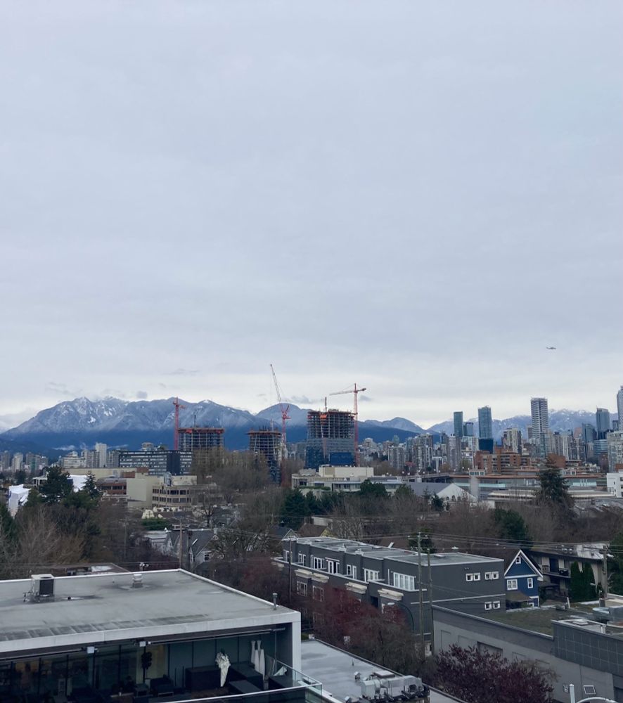 City with snow peaked mountains in the background.
