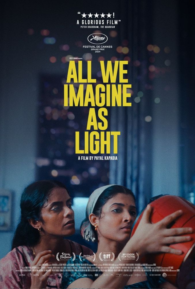 Image of one of the promotional posters for the 2024 film All We Imagine As Light by Payal Kapadia, showing the characters of Malayalis Prabha (played by Kani Kusruti) and Anu (played by Divya Prabha) in a scene where they inspect a new fangled rice cooker shipped to Prabha from her husband in Germany. 