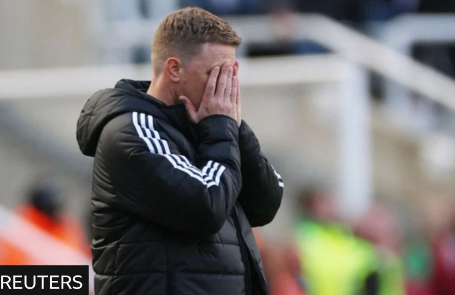 Eddie Howe with his hands over his face 
