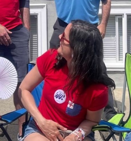 A woman with a Michelle Wu sticker looks back at Josh like what the hell