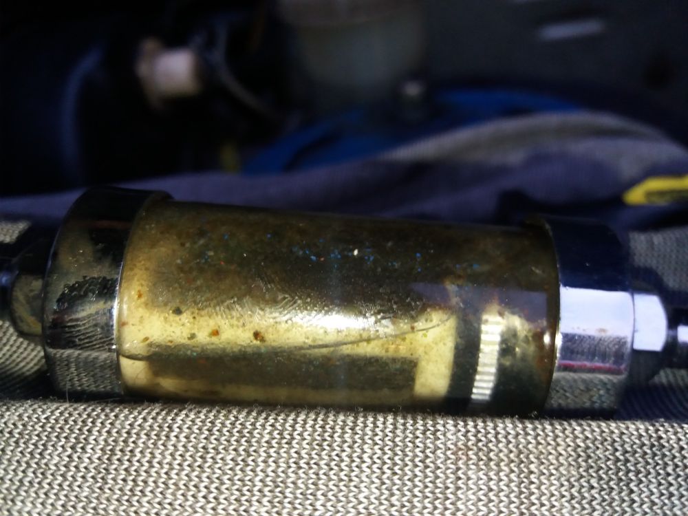A very dirty and clogged petrol fuel filter.