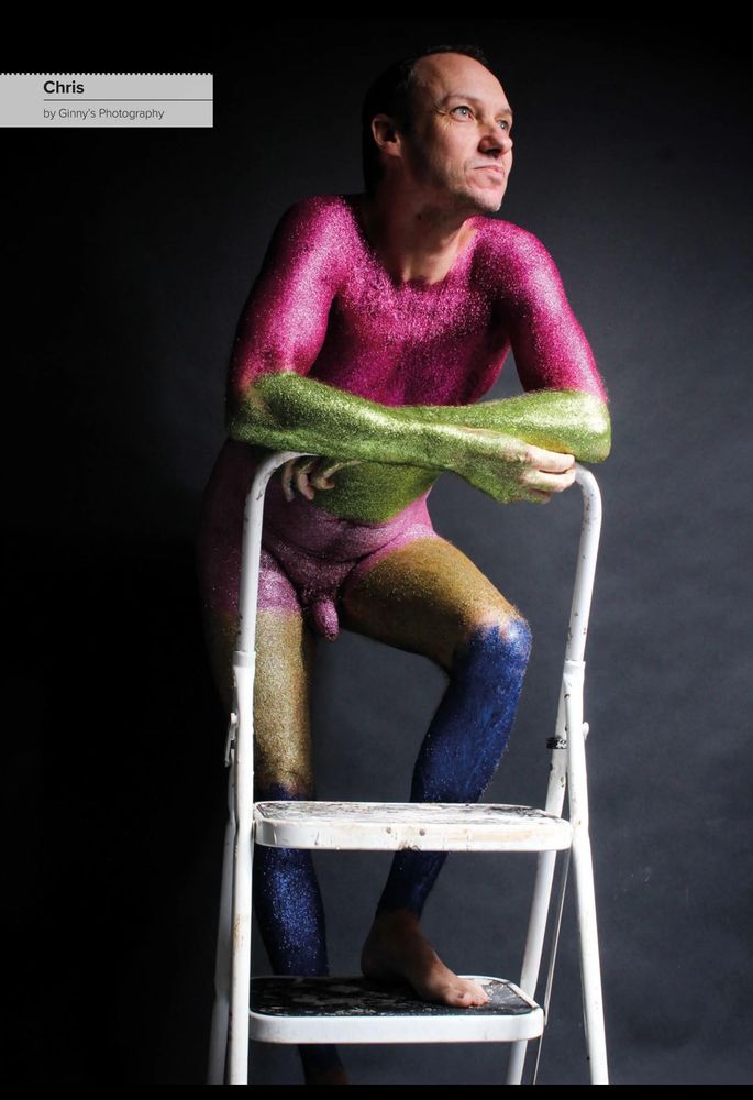 Magazine article promotion body positivity through non-sexual nudity. Male nude covered in body glitter. 