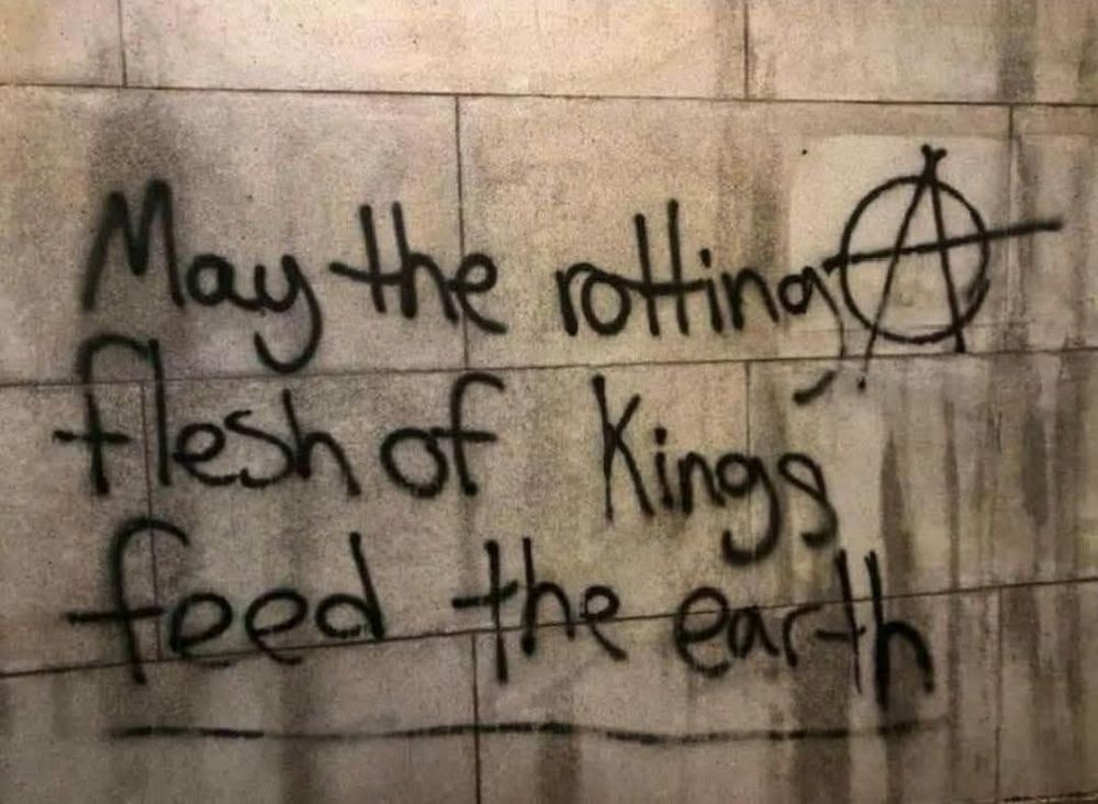 Graffiti reading“may the rotting flesh of kings feed the earth”