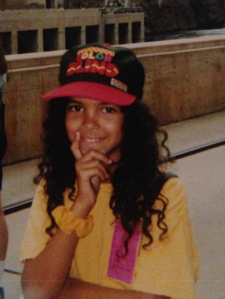 Adolescent Skye standing at the (Hoover Dam?) with long curly dark hair, a yellow shirt with a pink tag on it, a yellow scrunchie on her wrist and a red black and yellow “Color blind” hat. It was the 90s and this phrase wasn’t a problem yet, I don’t think.. 