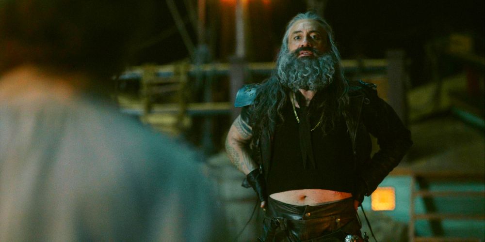 ed teach on the deck of the revenge putting his hands on his back to push his tummy forward a bit more so it peeks out from under the shirt, this strategy aims to draw in the nearest unsuspecting top (our flag means death s1e6)