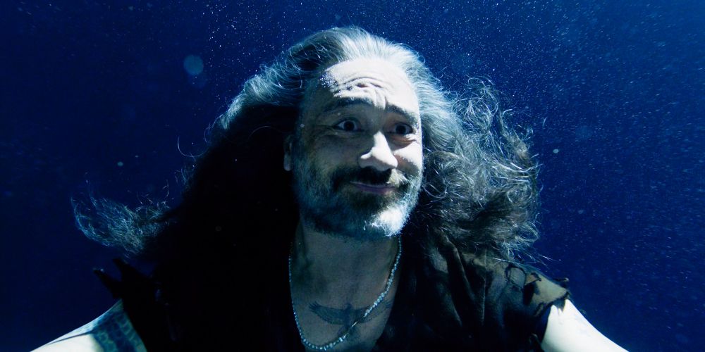 ed teach underwater in his gravy basket having just decided to choose live, smiling with joy and hope in his eyes, looking over at merstede having just appeared in the darkness all sparkly and orange and gorgeous (our flag means death s2e3)