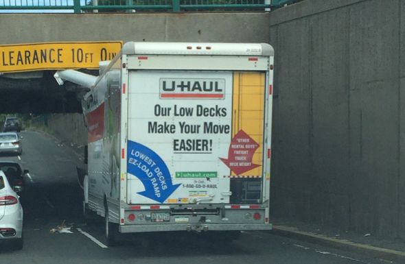 A U-Haul truck getting "Storrowed" (running into one of the low bridges on Storrow Drive)