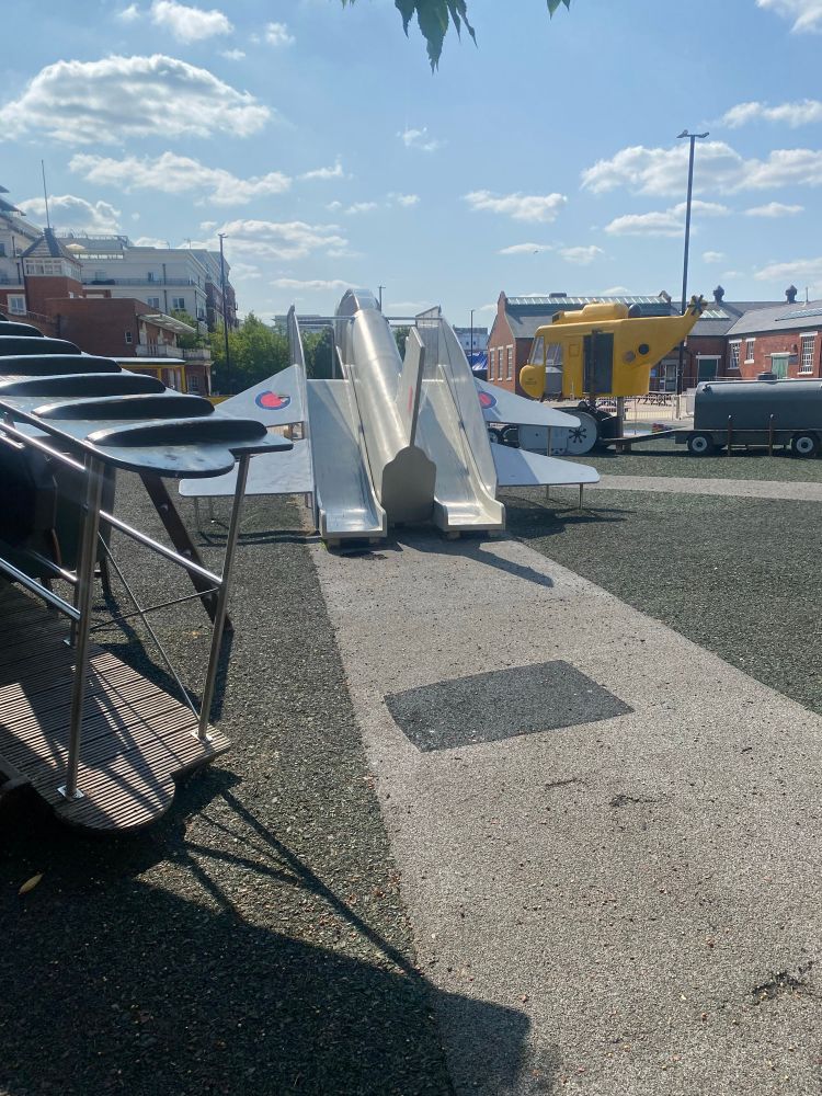 Rear view of the RAF Hendon playground with a spitfire turned double slide 