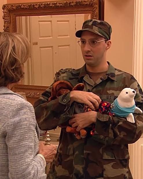Buster from arrested development holding plush toys. 