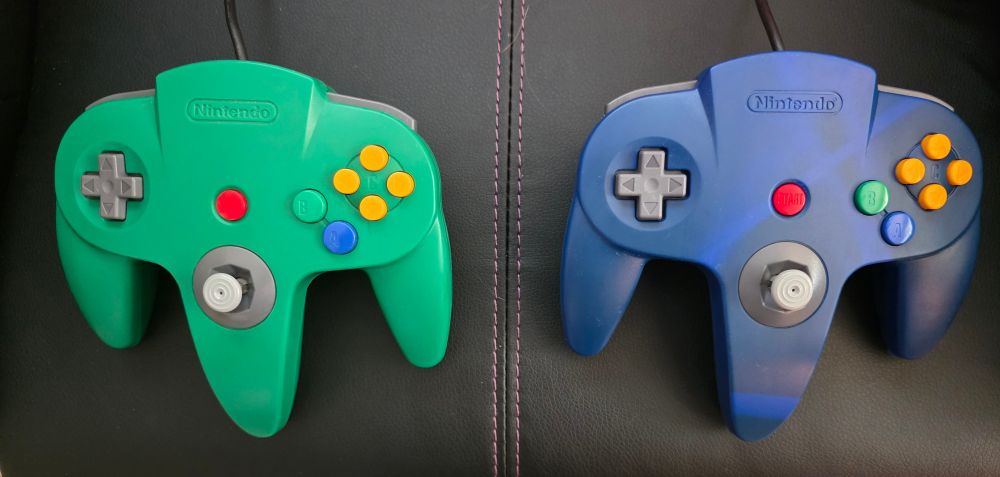 Blue and green Nintendo 64 controllers after cleaning and stick repair. 