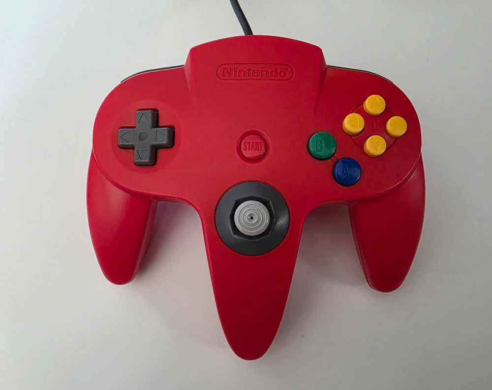 A red Nintendo 64 controller. 