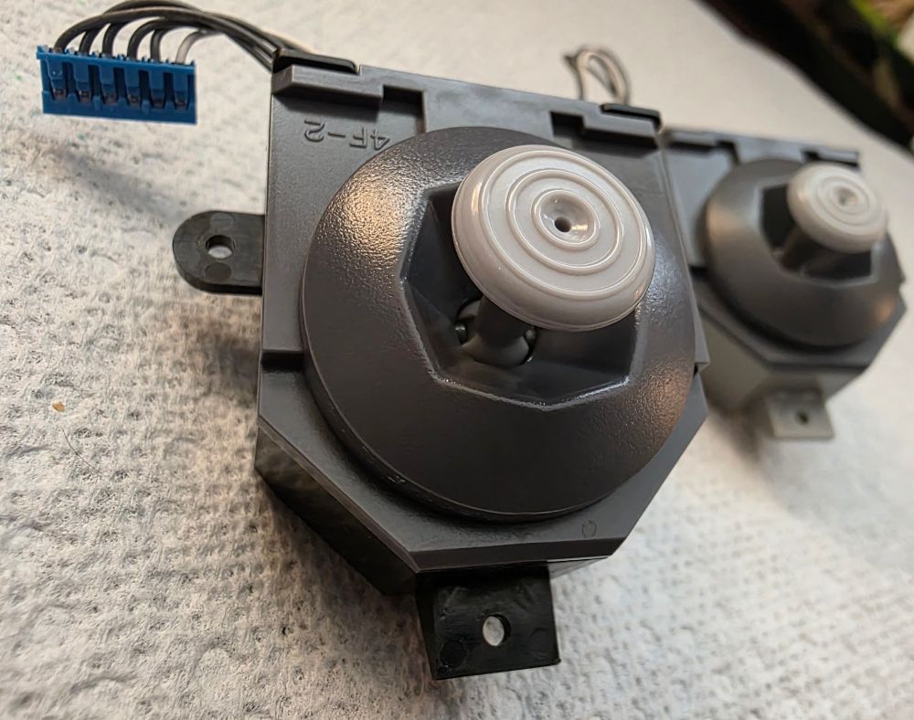 Two joystick assemblies for a Nintendo 64 controller. 