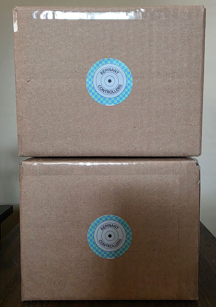Two boxes containing Nintendo 64 controllers with the Remnant Controllers logo. 