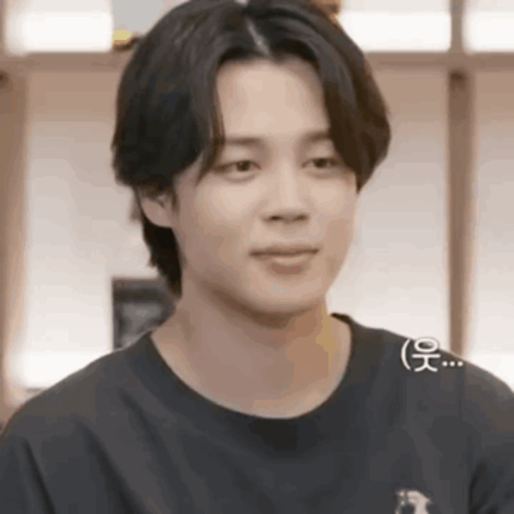 a close up of a young man wearing a black t-shirt .