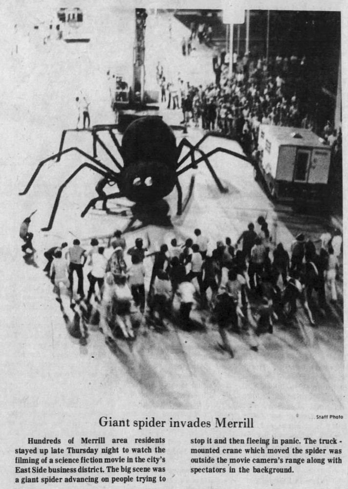 A 35-foot black spider is manipulated by a crane during the filming of a scene for "The Giant Spider Invasion," a science fiction film, in downtown Merrill, Wisconsin, on Thursday, July 17, 1975 -- 50 years ago tonight.