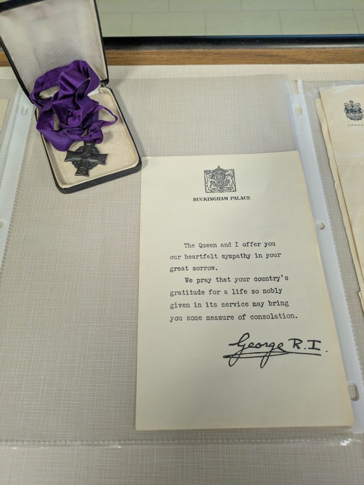 A memorial cross given to the mother of Harry George Dickson Jr and a form letter of sympathy from Buckingham Palace