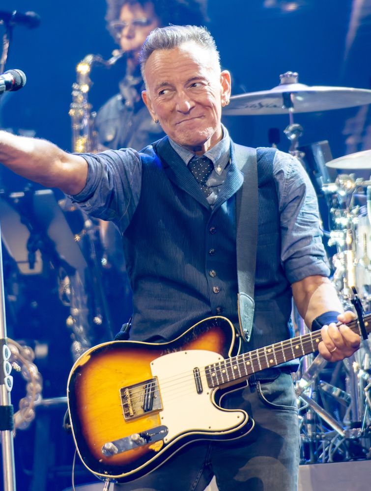Bruce Springsteen, a white older man, holding a telecaster style guitar 