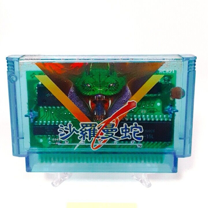 A clear blue game cartridge about the size of a cassette tape with Japanese writing and a space snake in a triangle 