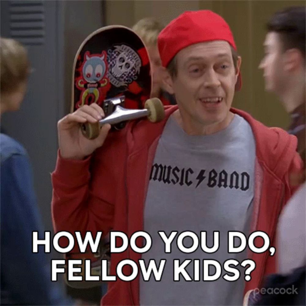 a man wearing a music band shirt is holding a skateboard over his shoulder