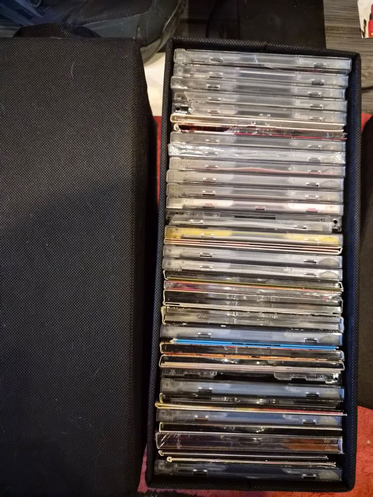 One of the CD boxes open. It's filled with albums, but the side facing up doesn't have any identifying labels on it.