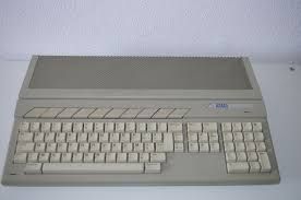 Atari ST 1040 home compute. It's a beige-colored, all-in-one unit with an integrated keyboard and a distinct rectangular housing for the internal components. The function keys have a typical slanted design.