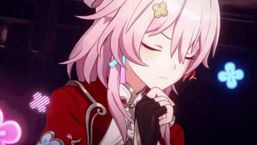 a girl with pink hair is wearing a red jacket and gloves and has her eyes closed .