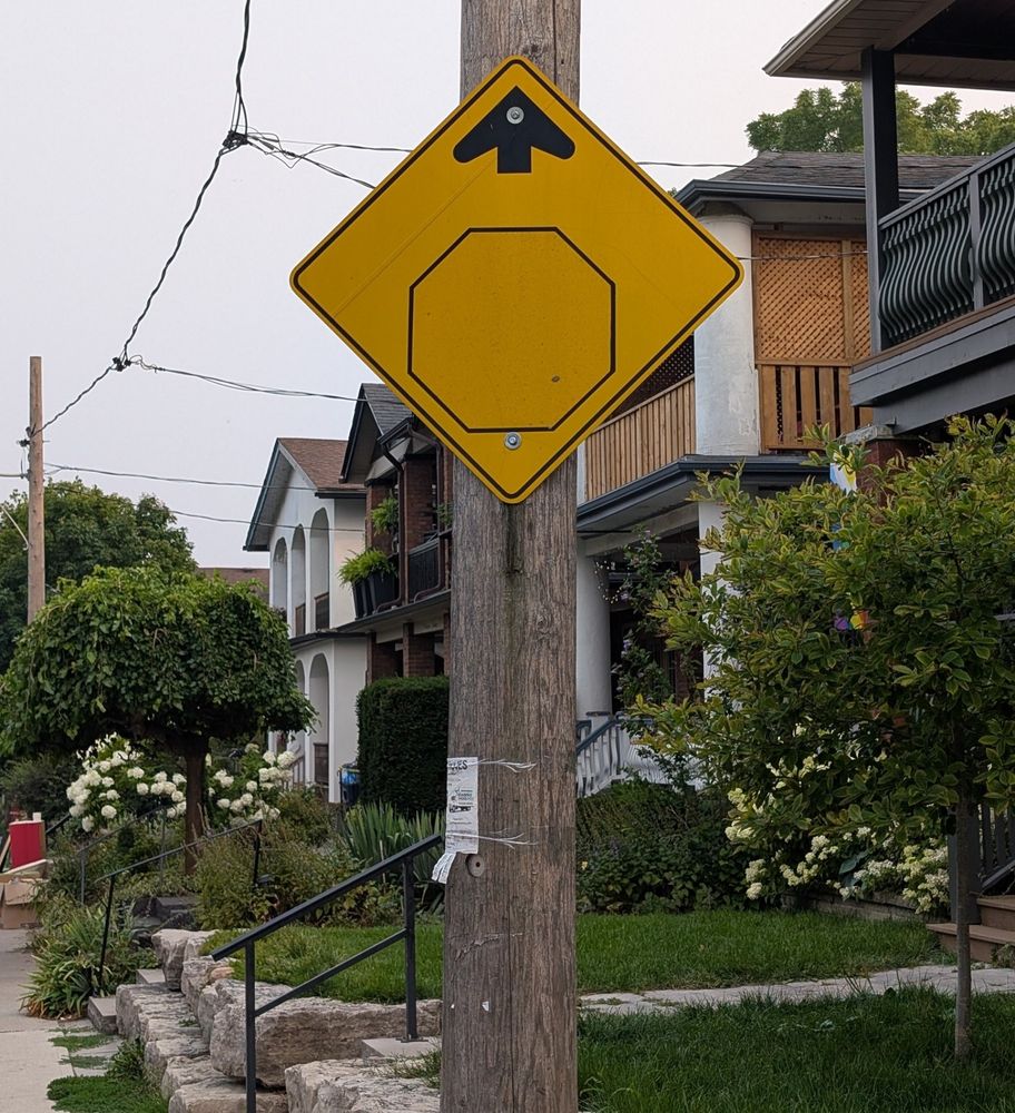 An old stop sign warming sign but it's faded so no stop sign is visible 
