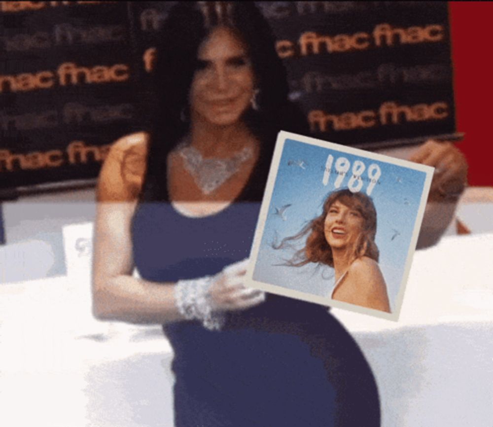 a woman holds up a picture of a woman from the year 1989