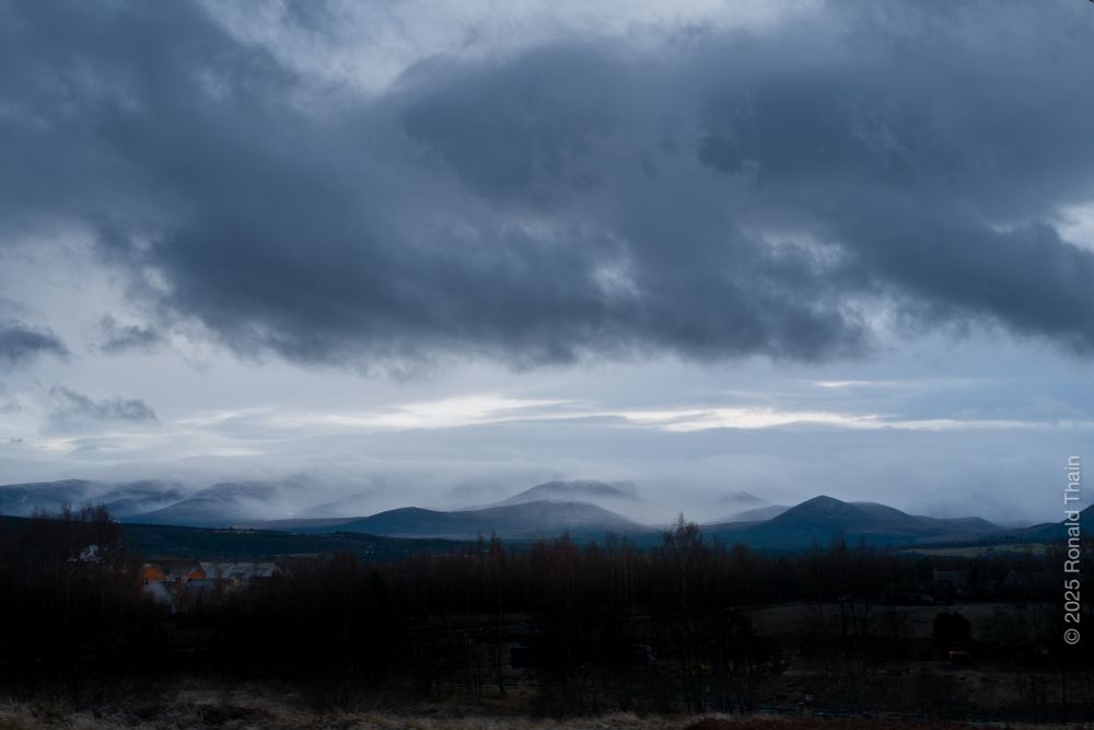 A panoramic photo of the Cairngorm plateau, Highlands of Scotland. The summit of Cairngorm is hidden as a cold misty rain drifts across the face of the northern corries.