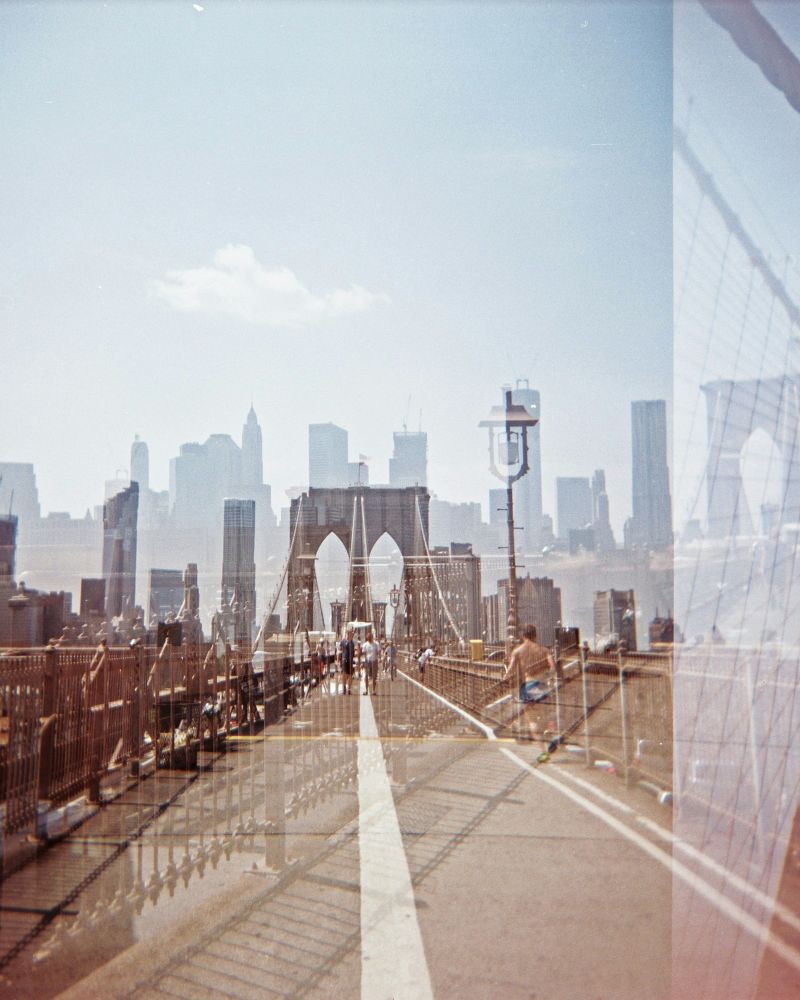 Holga 120 lomography double exposure of NYC and the Brooklyn Bridge. (image: Sandy Hibbard/Unsplash)