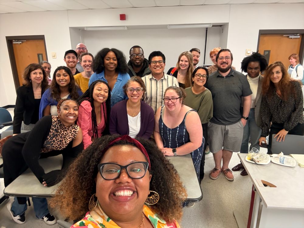 A group photo of guest speaker Dr. Angeline Dukes taking a selfie with the IRACDA INSPIRE program inside a classroom at Rutgers