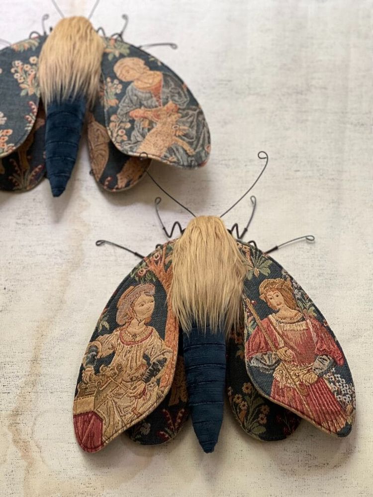 two moth sculptures made from textile and wire