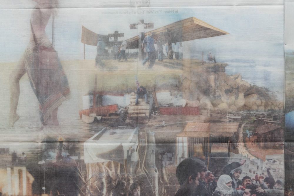 a detial image of a large-scale installation of imagery printed from newspapers