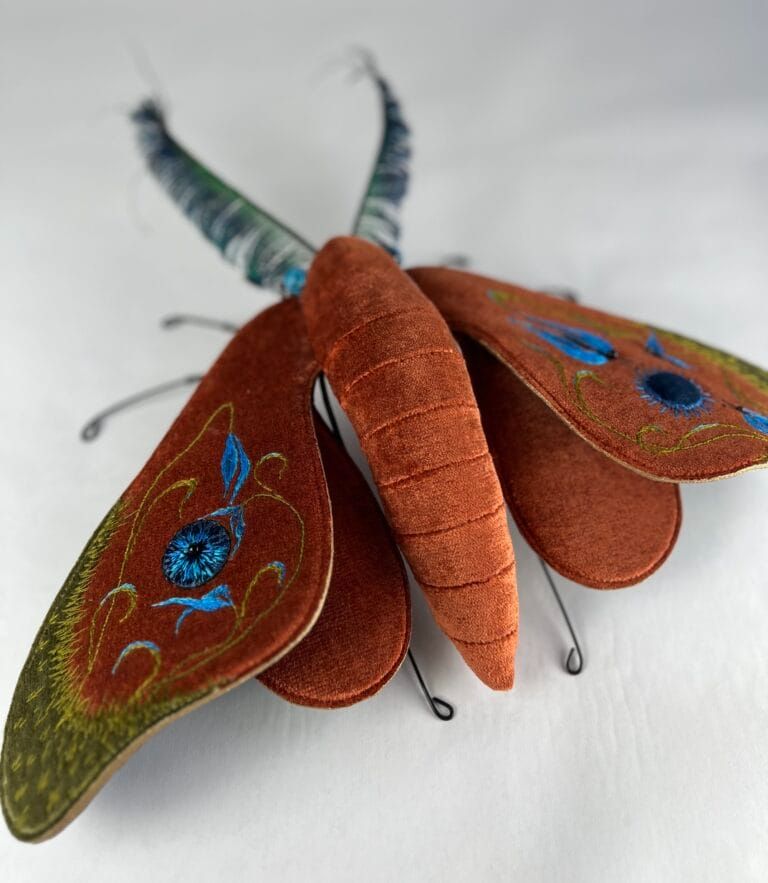 a moth sculpture made from textile and wire