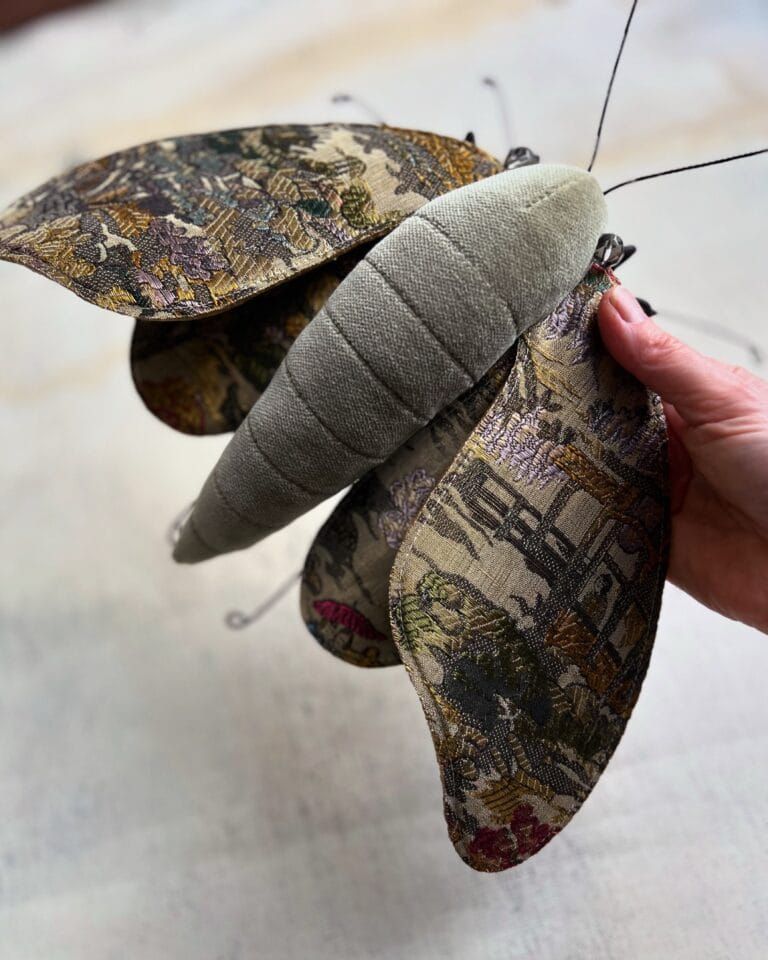 a moth sculpture made from textile and wire