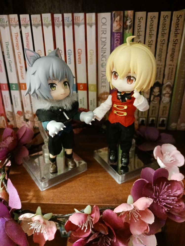Nendoroid dolls of a wolf and a vampire holding hands and seeming to gaze at each other lovingly