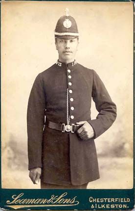 Historical black and white photograph of a policeman in uniform