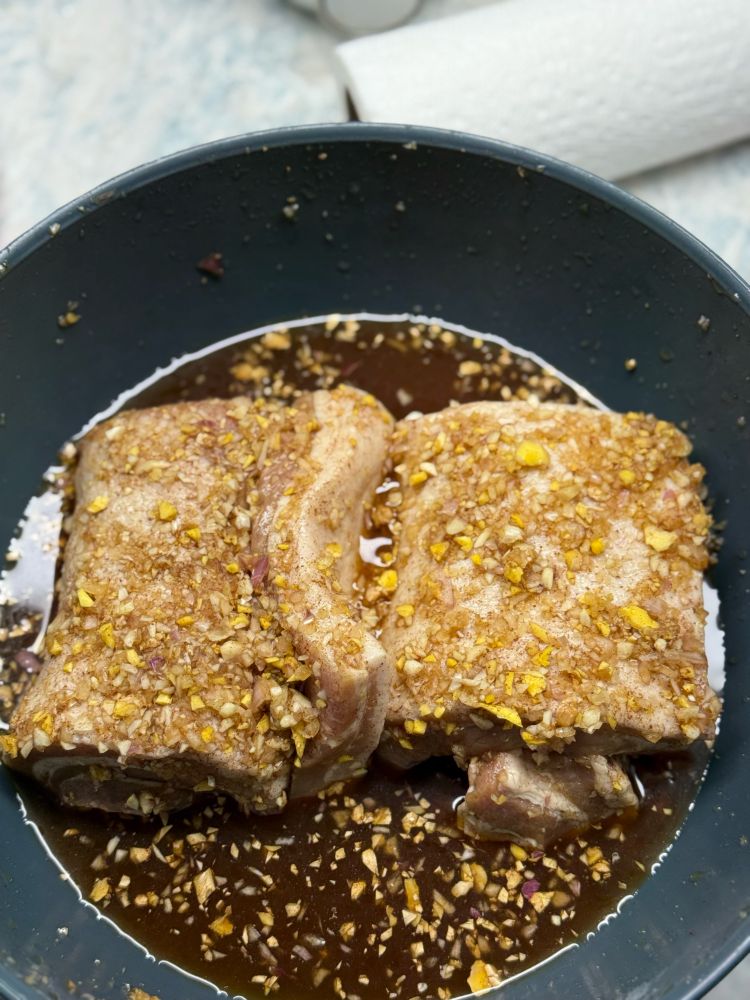 2 rolled up pieces of pork belly, marinating in garlic, ginger, shallots, 5 spice, soy sauce and water. 