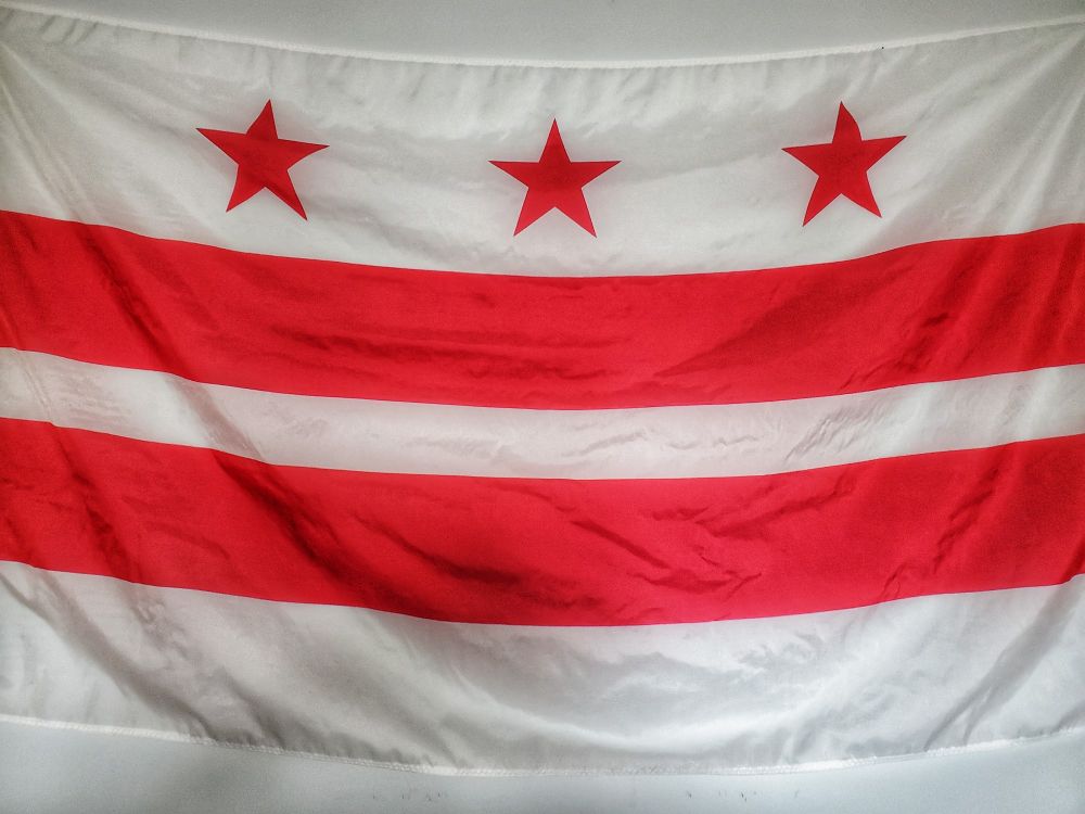 The flag of Washington DC hanging on my office wall