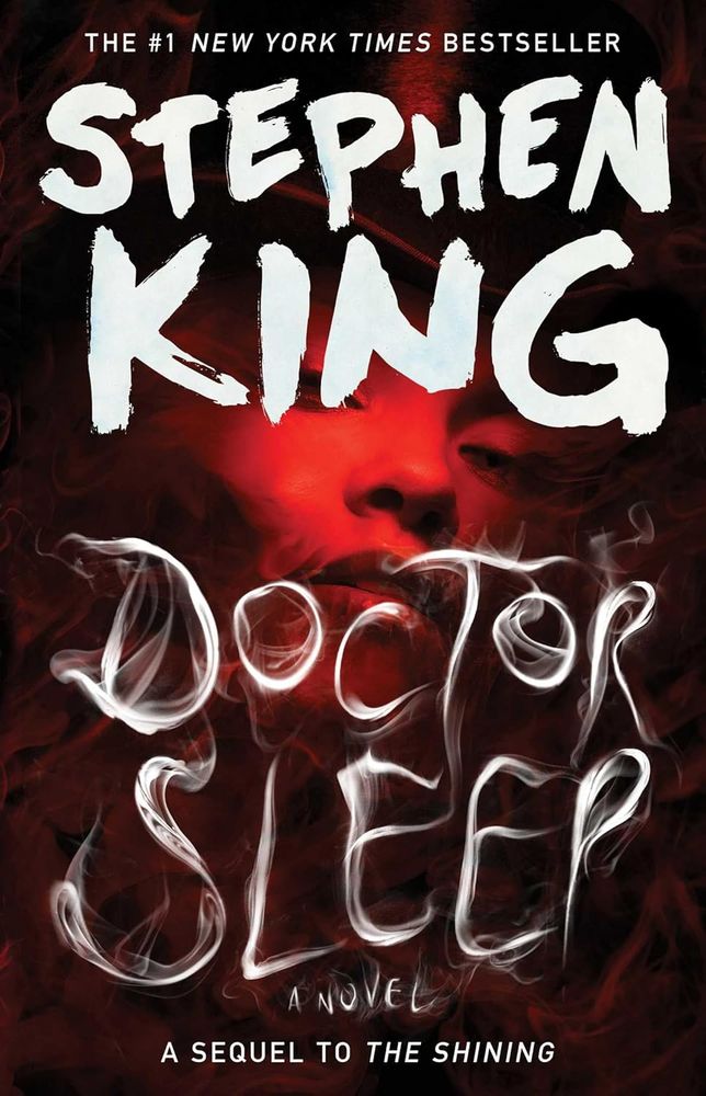 Cover for Stephen King's DOCTOR SLEEP. There's a woman bathed in red and wearing a black top hat looking at you from the center of the cover.