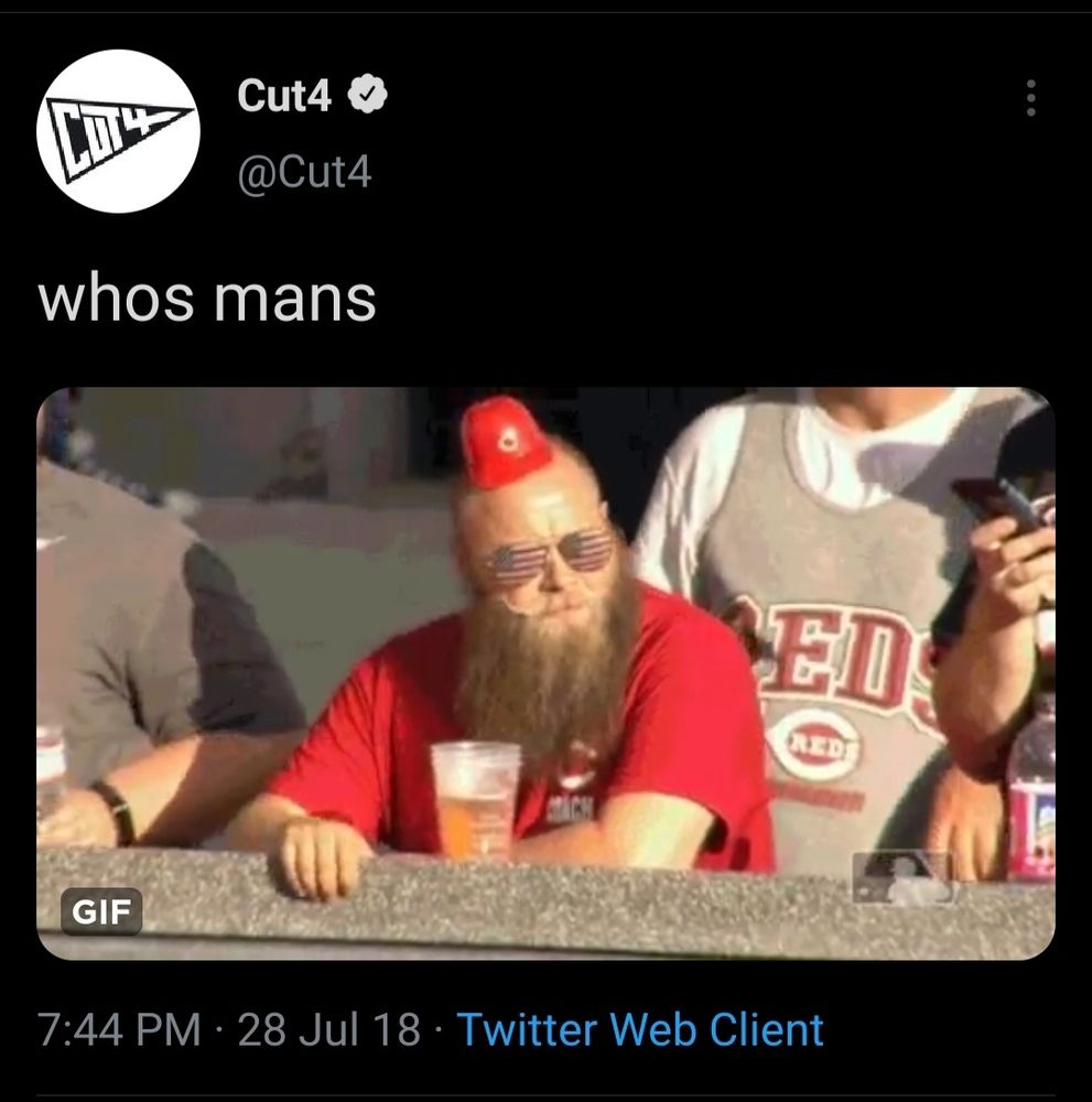 Bearded man in a tiny ice cream hat. 