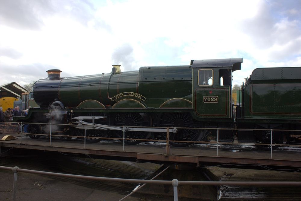 British Railways "Castle" class locomotive "Clun Castle", on a turntable at an open day at Tyseley, Birmingham. 

The locomotive is in a dark green livery. Wisps of smoke can be seen. 

Copyright Robert Eva.