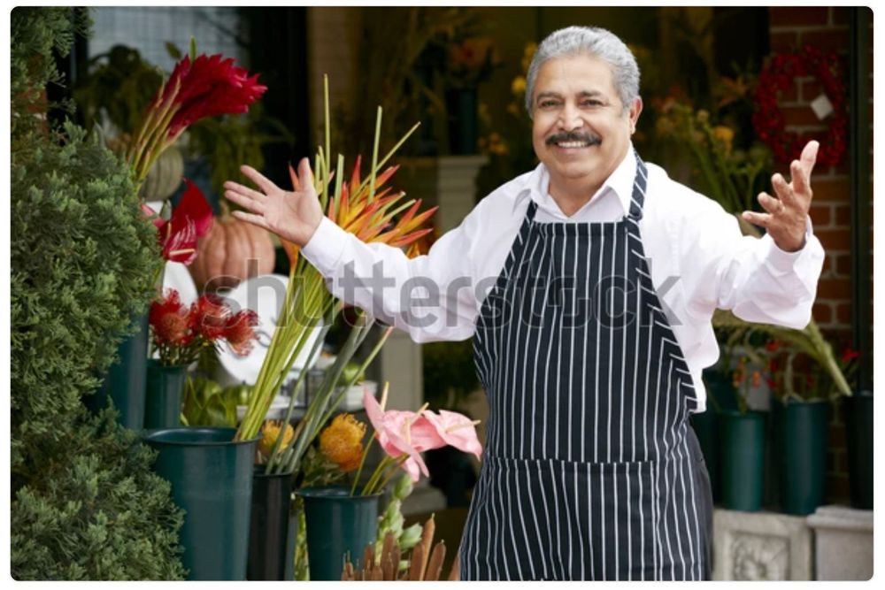 A watermarked stock photo of an older Italian gentleman in an apron, a shop owner of some kind, stepping up with a smile and his arms open in greeting. It’s the same picture every day. Today he is trying out a salsa station on the shop speakers!