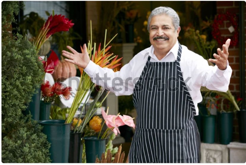 A watermarked stock photo of an older Italian gentleman in an apron, a shop owner of some kind, stepping up with a smile and his arms open in greeting. It’s the same picture every day. Today he has “eclipse fever”!