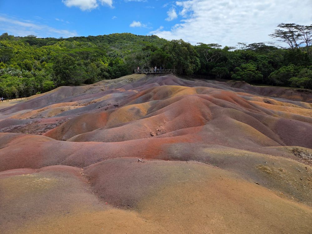 7 colored earth is an area that has, well, 7 distinct colors of earth! They DON'T mess around with their naming of sites.
The different oxides make the various colors. 
